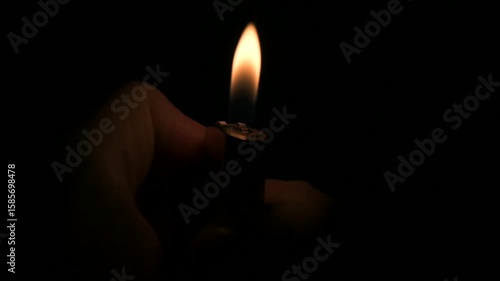 Lighters with flame on dark background. Selective focus.
