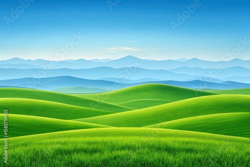 Rolling green hills under a vast blue sky with layered mountains