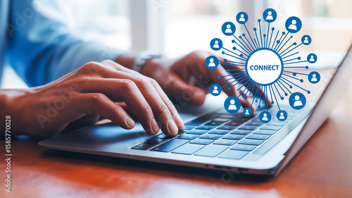 A close-up photograph of hands typing on a silver laptop keyboard with a social media network visualization overl ay