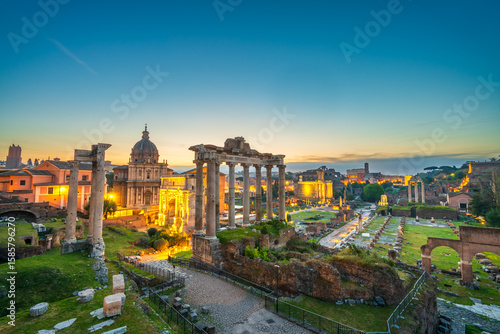 Roman forum ruins at sunrise in Rome with Inscription "Senatus Populusque Romanus incendio consumptum restituit" - The Senate and People of Rome restored what had been consumed by fire