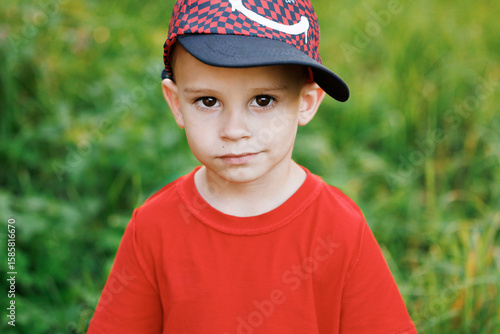 Portrait of little child kid boy looking at the camera at sunset. Funny boy posing at sunset having fun and positive emotion. Ambitious young people. Younger generation.