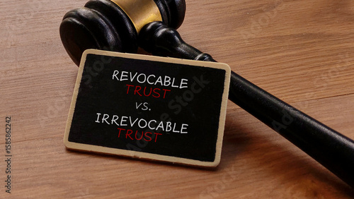 Fotografie Revocable vs. Irrevocable Trust with Gavel on Wooden Table