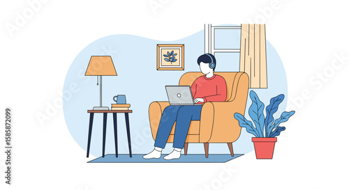 Young man working on laptop while listening to music in comfortable armchair at home office setup