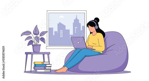 Young woman listening to music while working on a laptop in a comfortable beanbag chair by the window