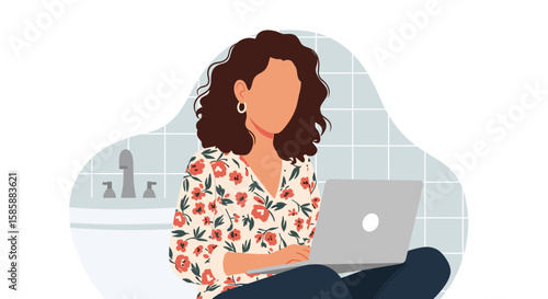 A woman with curly hair works on her laptop in a modern bathroom, enjoying a comfortable remote work setup.