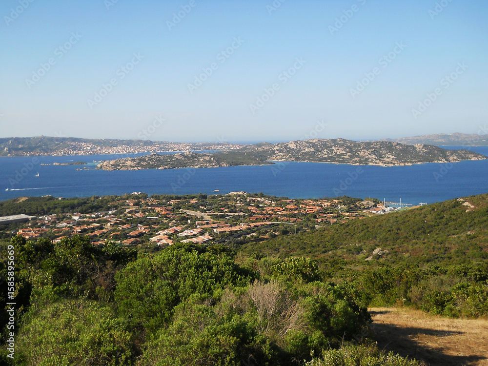 Obraz premium Panoramic View of Palau, Sardinia with La Maddalena Islands. Stunning panoramic view of Palau, a picturesque coastal town in northern Sardinia, Italy, overlooking the shimmering turquoise waters of
