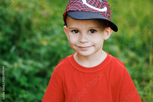 Portrait of little child kid boy looking at the camera at sunset. Ambitious young people. Younger generation. Lifestyle.