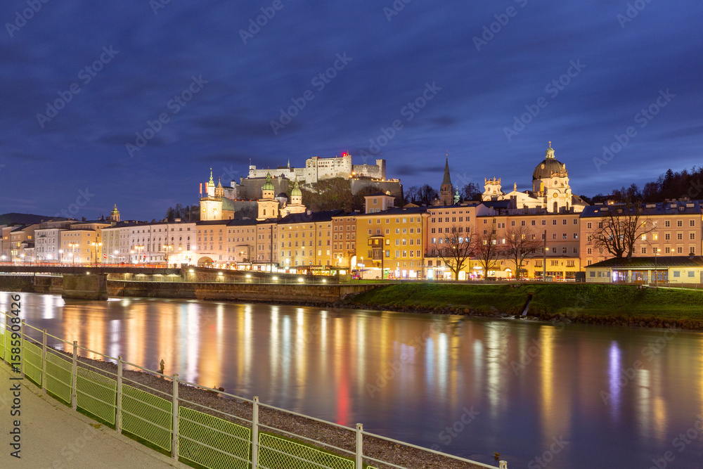 Fototapeta premium Hohensalzburg Fortress and historic city center illuminated at sunset in Salzburg, Austria