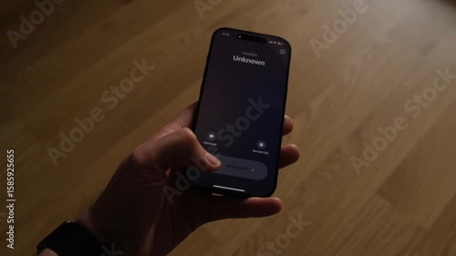 Fraud or fraudulent schemes. Close-up of a male hand holding a phone with an unexpected incoming call from an unknown