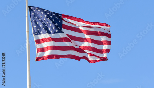 american flag of united states america usa blowing in the breeze flying high on flag pole patriotic patriotism national nationalism symbol banner fabric photo photography close up macro stars stripes