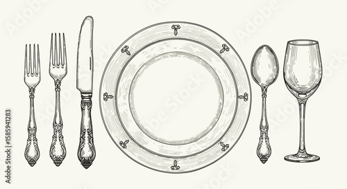 Elegant vintage tableware set with ornate cutlery and plate