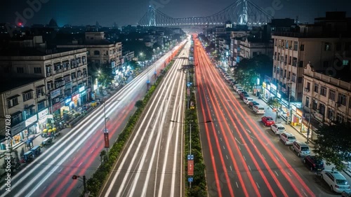 Busy Night Traffic Flows Under a Bright City Skyline in Kolkata, India