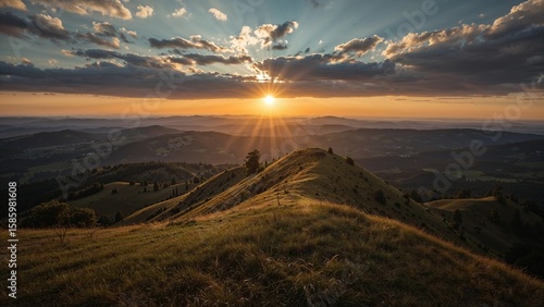 Golden sunset over rolling hills and valleys.