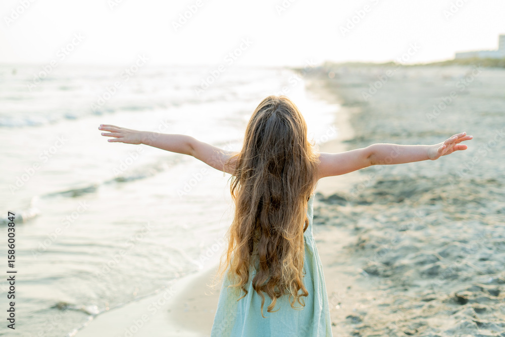 Portrait of a little girl near the sea at sunset. Child on the beach. Sea vacation. Portrait of a little girl near the sea at sunset. Child on the beach. Sea vacation.