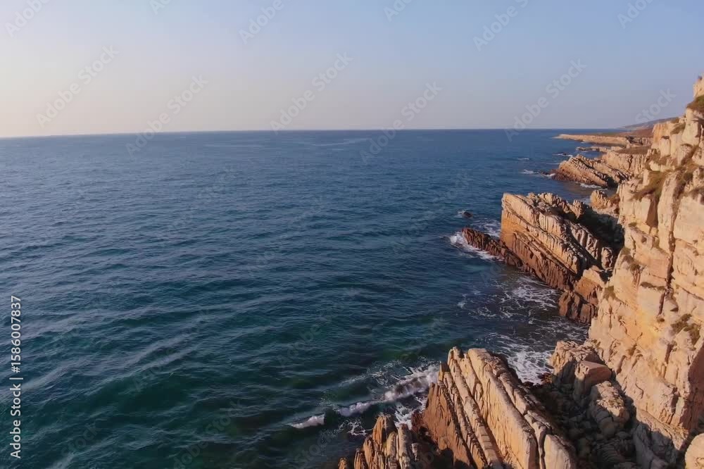 Coastal cliffs overlooking serene blue waters at sunset in a tranquil natural landscape Coastal cliffs overlooking serene blue waters at sunset in a tranquil natural landscape