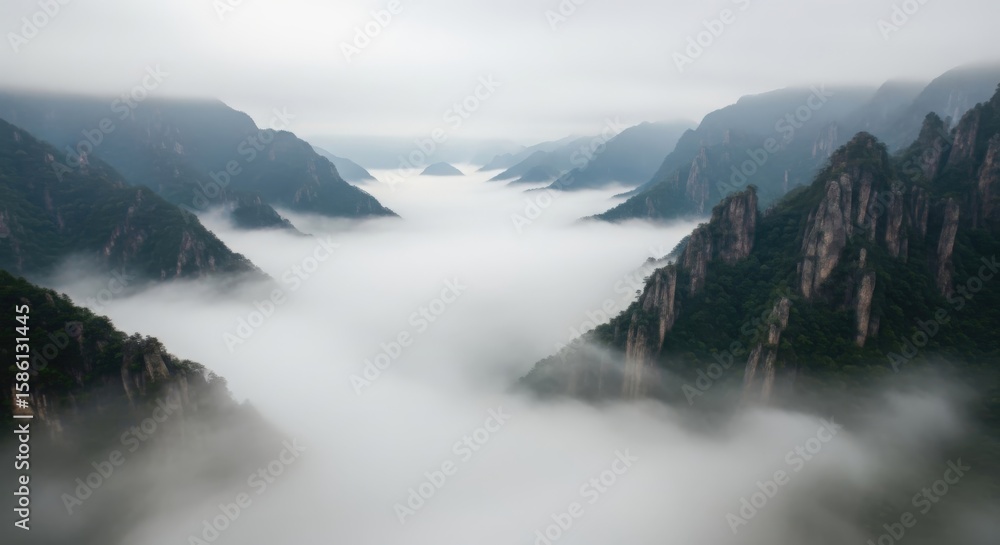Obraz premium Mystical Mountain Vista: The photo captures an ethereal mountain vista shrouded in a misty fog, showcasing the grandeur of nature and evokes a sense of peace and serenity. 