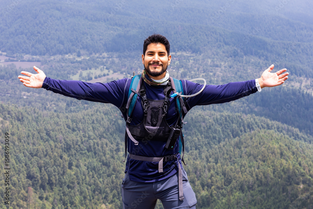 Hiker enjoying nature with open arms on a mountain Hiker enjoying nature with open arms on a mountain