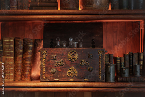 antique wooden chest along with books and old objects on wooden shelves