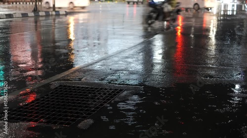 Wallpaper Mural A street with a lot of rain and a car driving by. The street is wet and the car is driving on it Torontodigital.ca