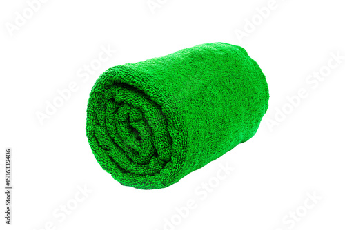 a green towel rolled up on a white surface