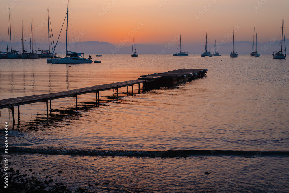 Fototapeta premium Sunset Serenity with Sailboats and Pier