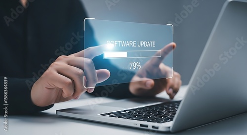 Software update on a laptop is being installed by a person, highlighting technology and the progress bar on the screen