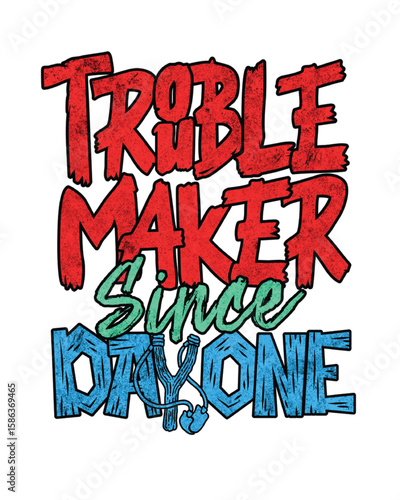 Troublemaker since day one distressed lettering with slingshot green blue