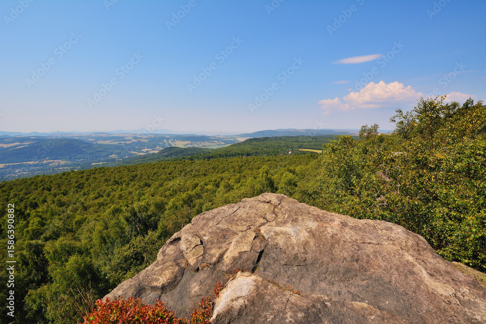 Fototapeta premium Rocky Hilltop in Summer Sunshine with Scenic Forest Landscape