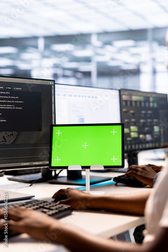 Wallpaper Mural System administrator in server hub ensuring data remains shielded from potential threats using mockup tablet. African american worker safeguarding data center against hackers with green screen device Torontodigital.ca