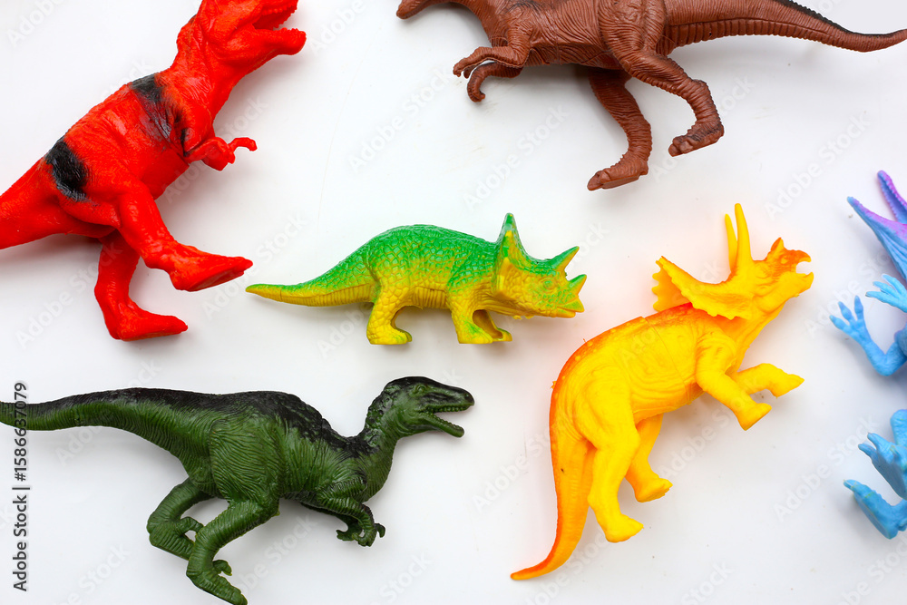 Fototapeta premium Plastic dinosaur toys on white background
