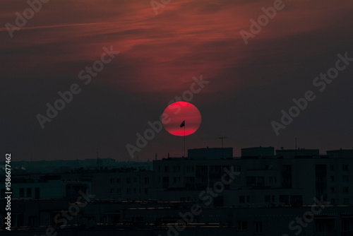 Red Sun Setting Behind Communist-Era Architecture in Eastern Europe