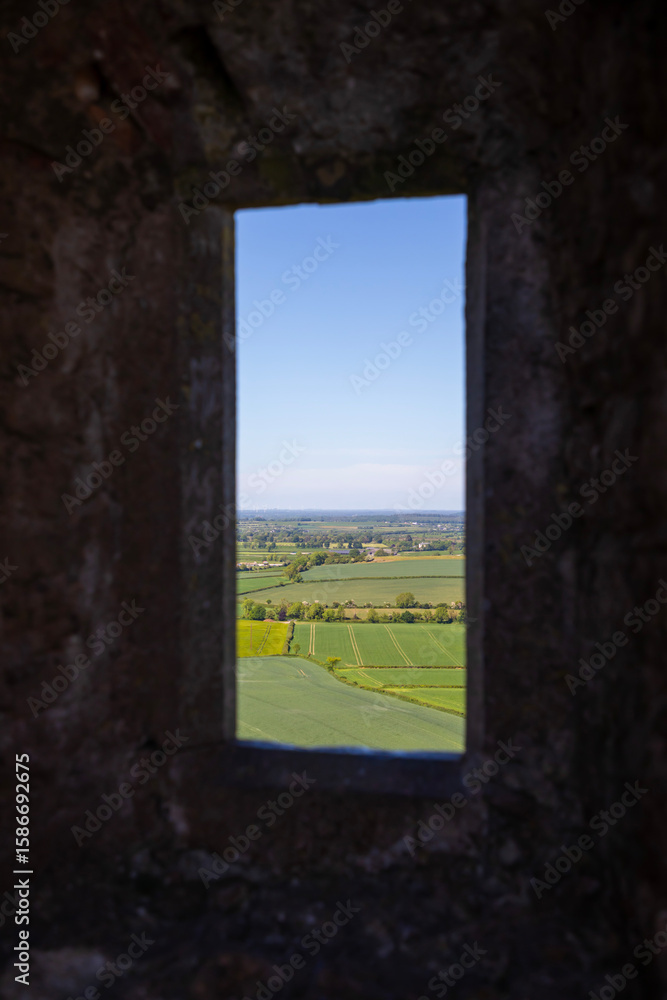 Fototapeta premium old castle window with view of fields
