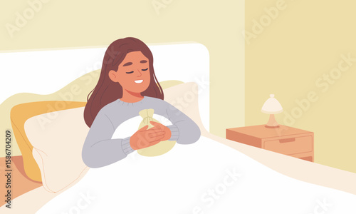 Woman in bed hugging a hot water bottle, looking content and cozy in a warm, light-filled bedroom.