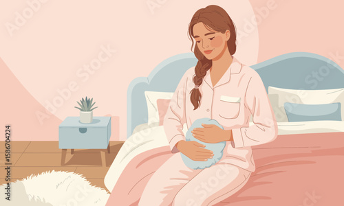 A woman in pajamas sits on her bed, holding a hot water bottle against her abdomen, seemingly experiencing discomfort.
