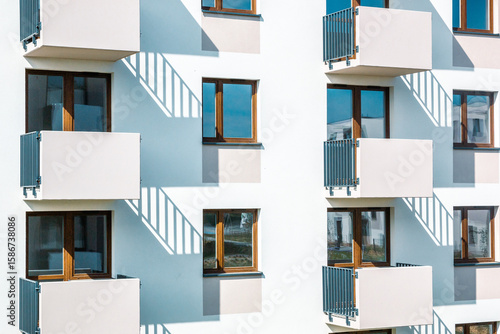 Modern apartment building facade with repetitive balconies and shadow play