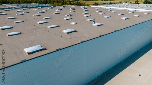 Aerial view of industrial warehouse roof with skylights and ventilation domes