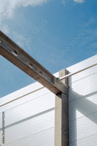 Concrete beam and insulated wall panel in industrial building construction

