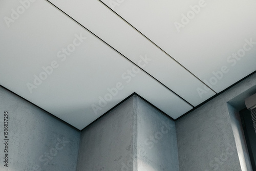 Minimalist modern ceiling with concrete and acoustic panels in interior