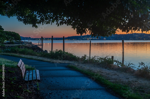 View From Seacrest Park of the Sunrise Over the City Of Seattle, Washington. One of the best places to enjoy the view of Seattle is in West Seattle looking across Elliott Bay from Seacrest Park.