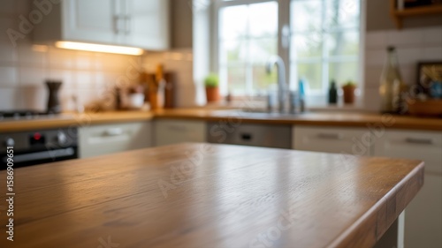 Modern kitchen with wooden countertop and bright natural light streaming through large windows