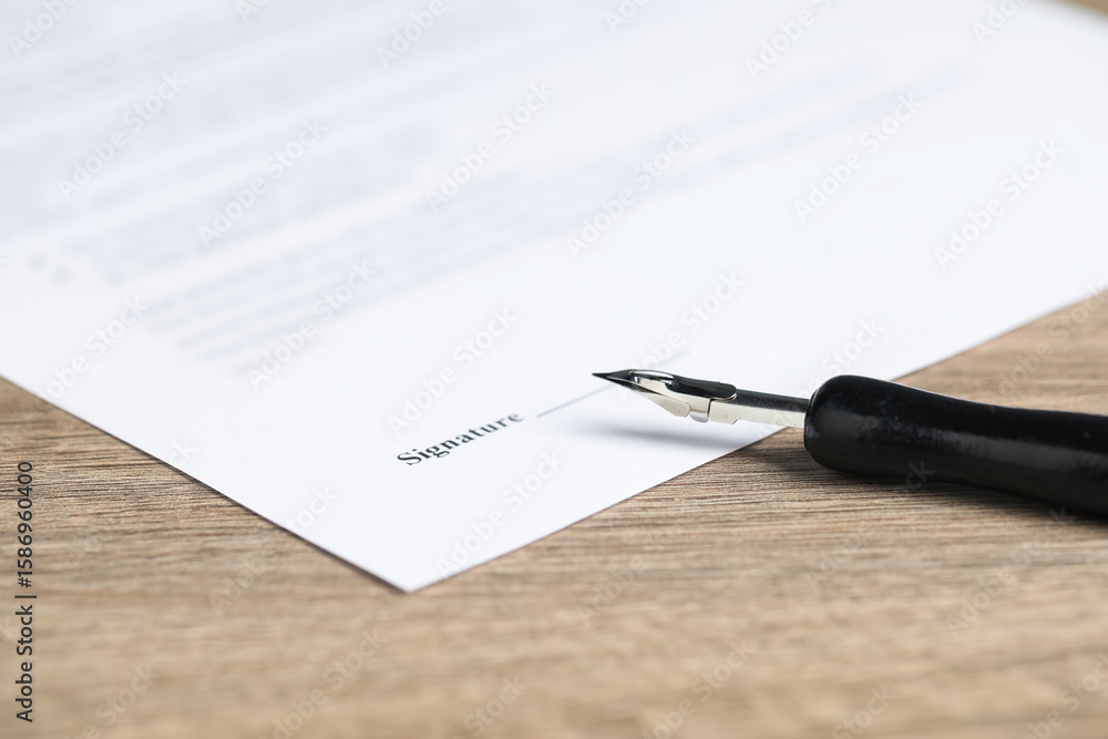 Fototapeta premium Notary document and fountain pen on wooden table, closeup
