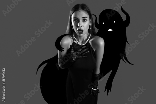 Scared young woman on dark ...