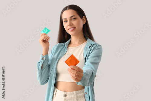 Young woman with condoms on...