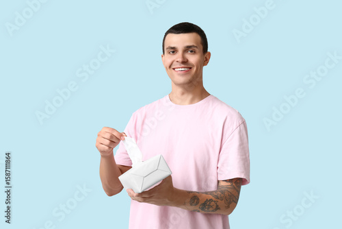 Ill young man with tissues ...