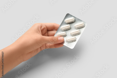 Female hand with pills in b...