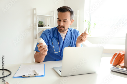 Handsome doctor with pill b...