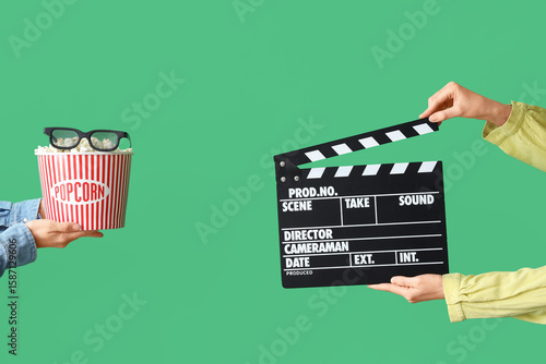 Hands with movie clapper, b...