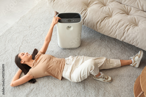 Young woman lying on floor ...
