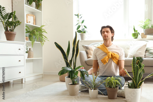Male gardener with plants m...