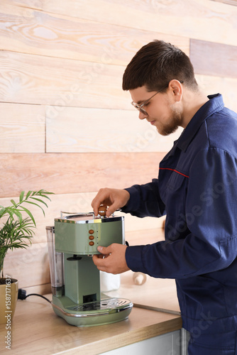 Male worker repairing coffe...